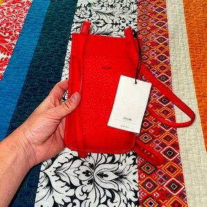 Colab phone case, red leather strap. New with tag, never used.